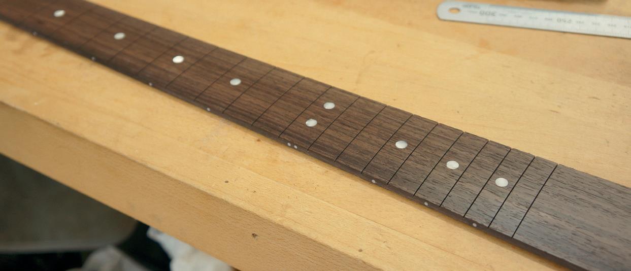 Rosewood fingerboard and dots positioned and sanded