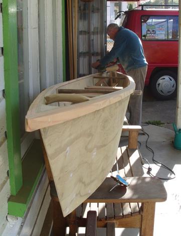 Strips of wood glued make the coaming. Short spreader is near front to allow room for paddles and outrigger to slip into the canoe for carrying.