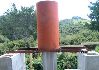 Welded angle-iron frame supports ﬁeld tile around ﬂue.