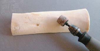 Dremel drill smoothes bare bone