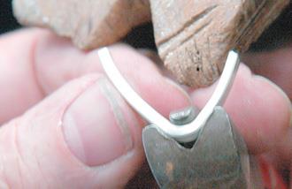 Bend with half-round soft pliers.