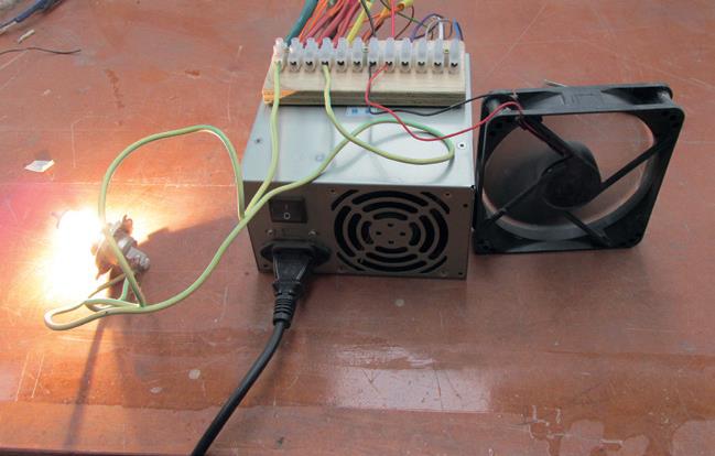 “Smoke Test”—switch on and see what smokes. Old headlamp bulb is connected between black (common) and yellow (+12v) wires. Load (fan) is spinning.