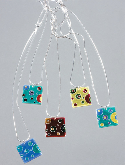 Finished enamelled pendants. Varied colours give different results even on a very simple design