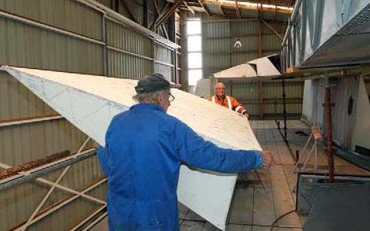 Don Barr and John Emeny fitting the fabric trailing edge section