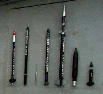 The previous test rockets hang on the wall.
