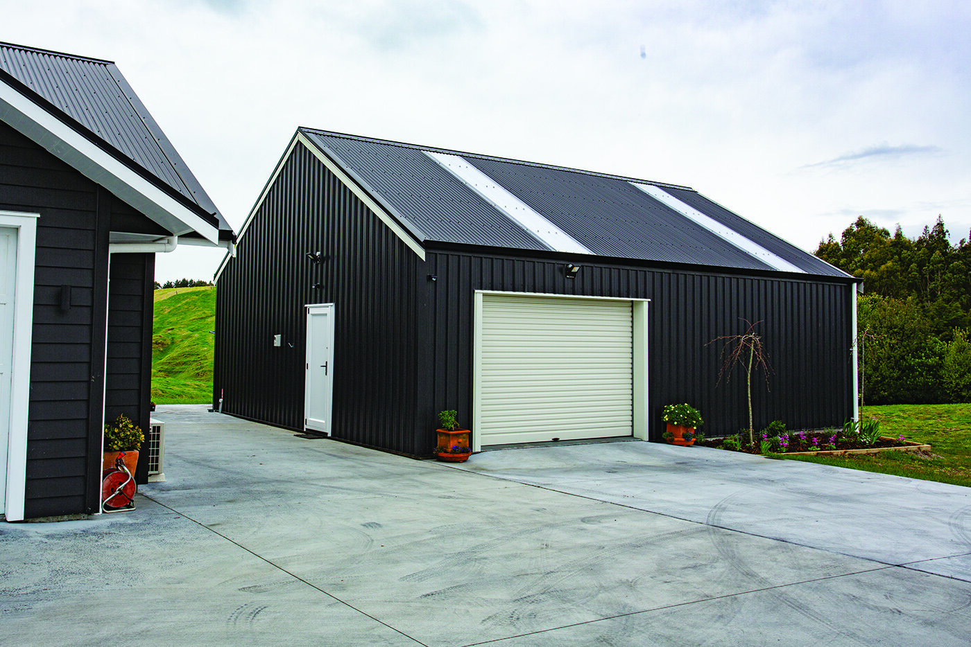 The steel shed perfectly complements the wooden home