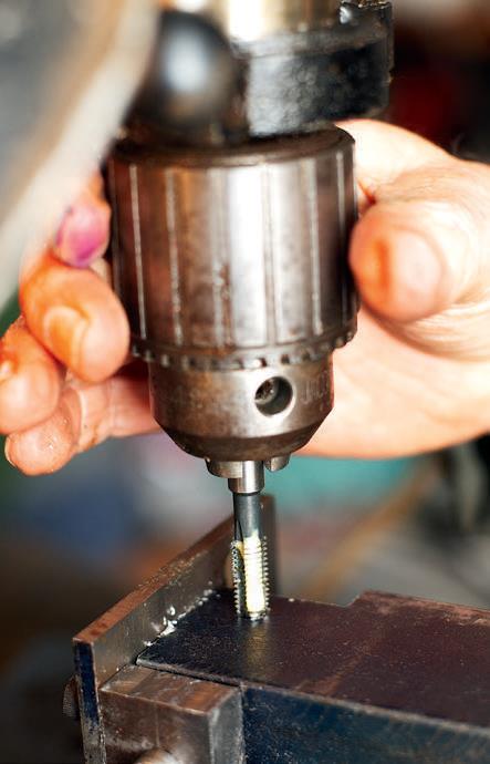 Starting the thread in the drill press ensures it is perpendicular.