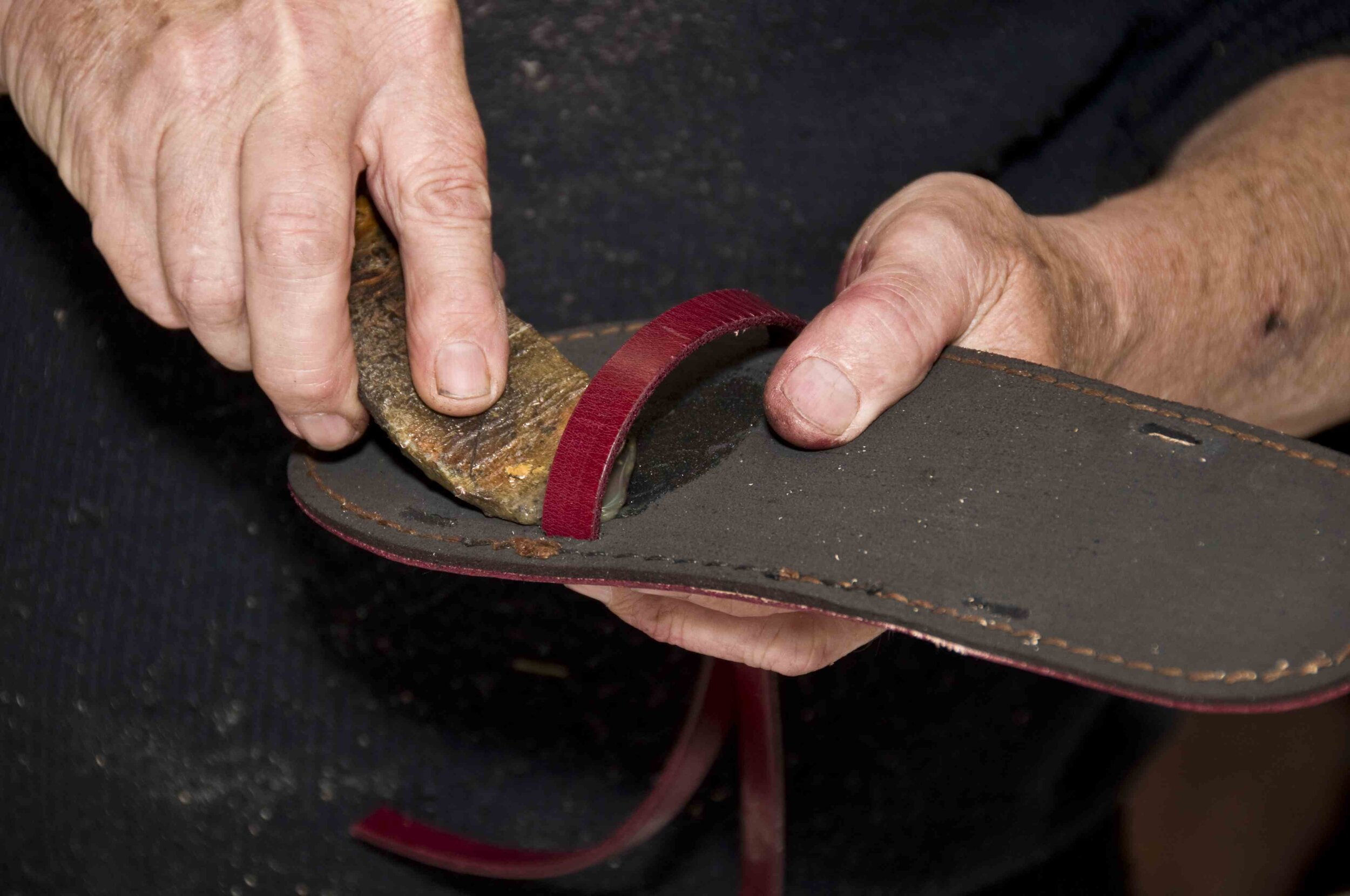 Attaching the long strap for the cross-strapped jandal. Remember to roughen the underside.