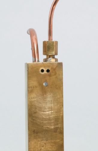 Brass stand with steam inlet and outlet.