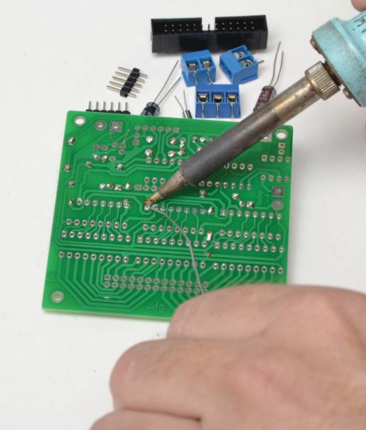 Soldering integrated circuit (IC) sockets.
