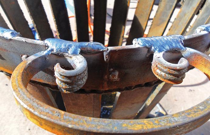 Bulky welding holds “curlies” as handles.