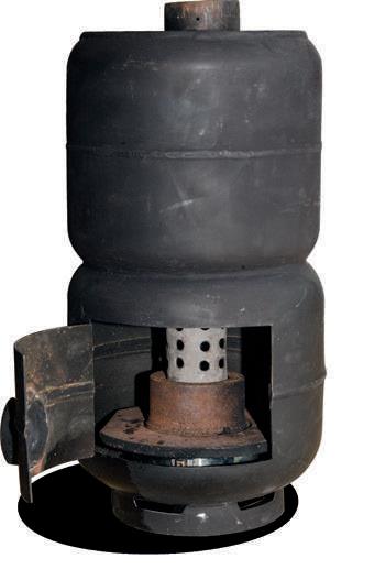 The Mighty Max has a device in the base made from an old brake drum which helps to hold the heat to vaporise the waste oil dripping into the interior.The burnerflue is in the centre.