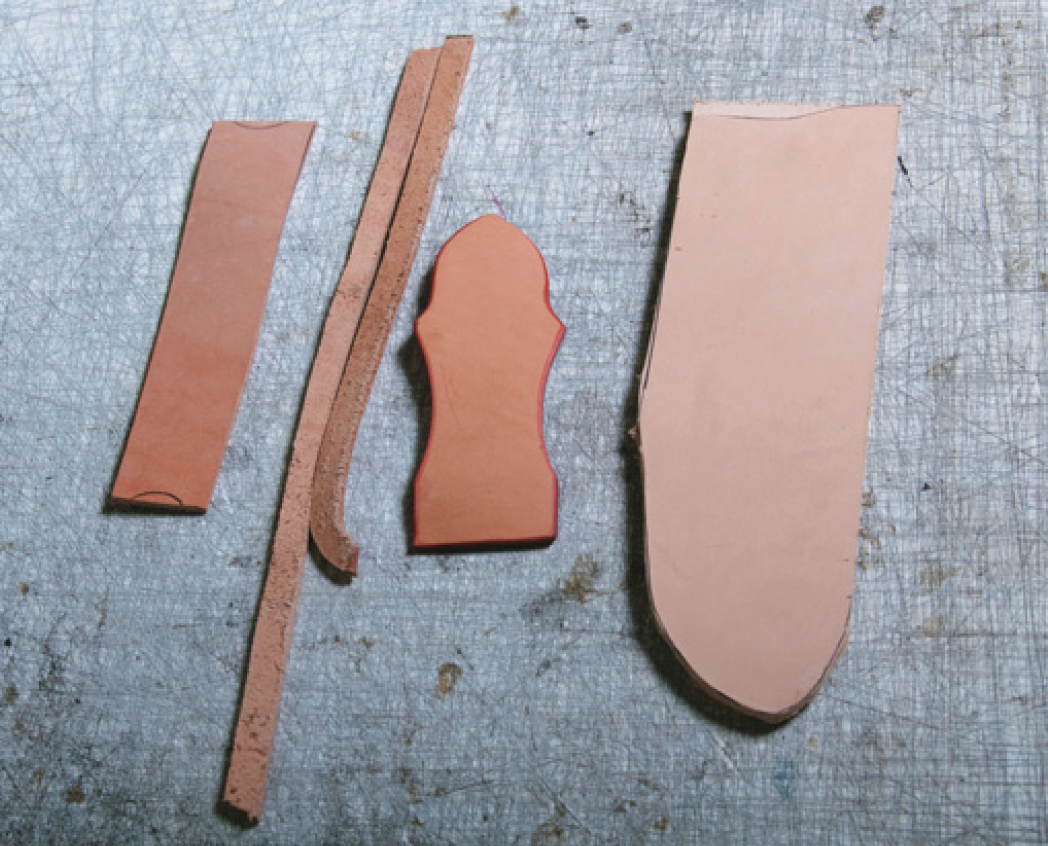 Leather pieces for (from left) sleeve for the steel, spacer strips, belt loop, sheath. 