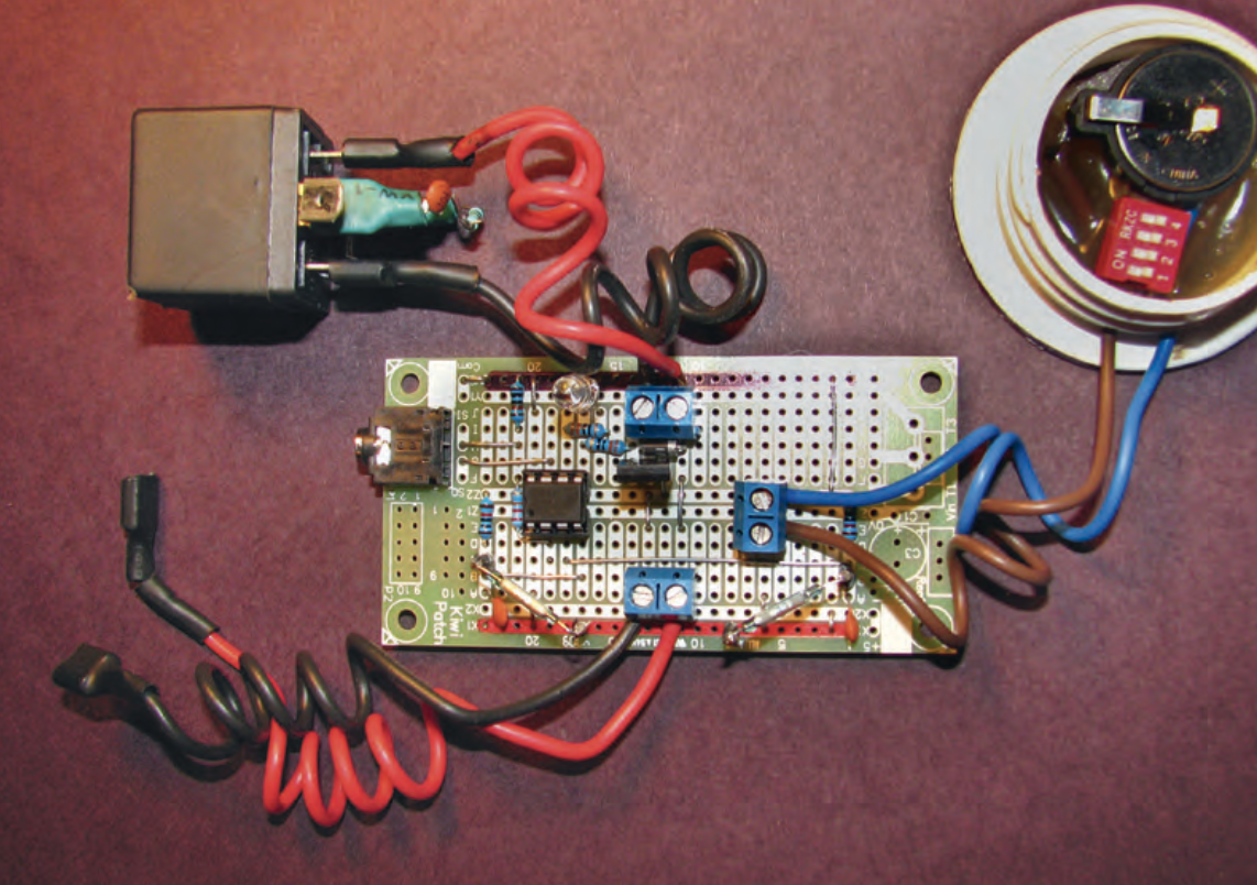 Timer assembly showing automotive relay with snubber (top left) and 3 v lithium battery with switch (top right).