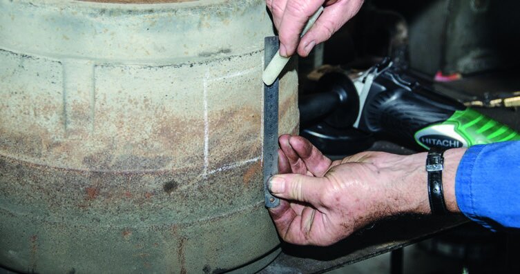Cutting the chimney opening with an angle grinder. Take care not to get the blade jammed. Below:  Bashing through the hole is the fastest way to remove the metal and then cleaning up the opening with a cold chisel.