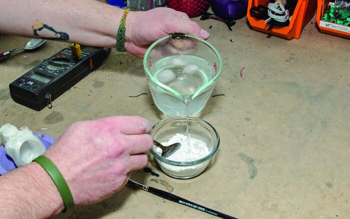 Mixing plaster with iced water to slow the reaction
