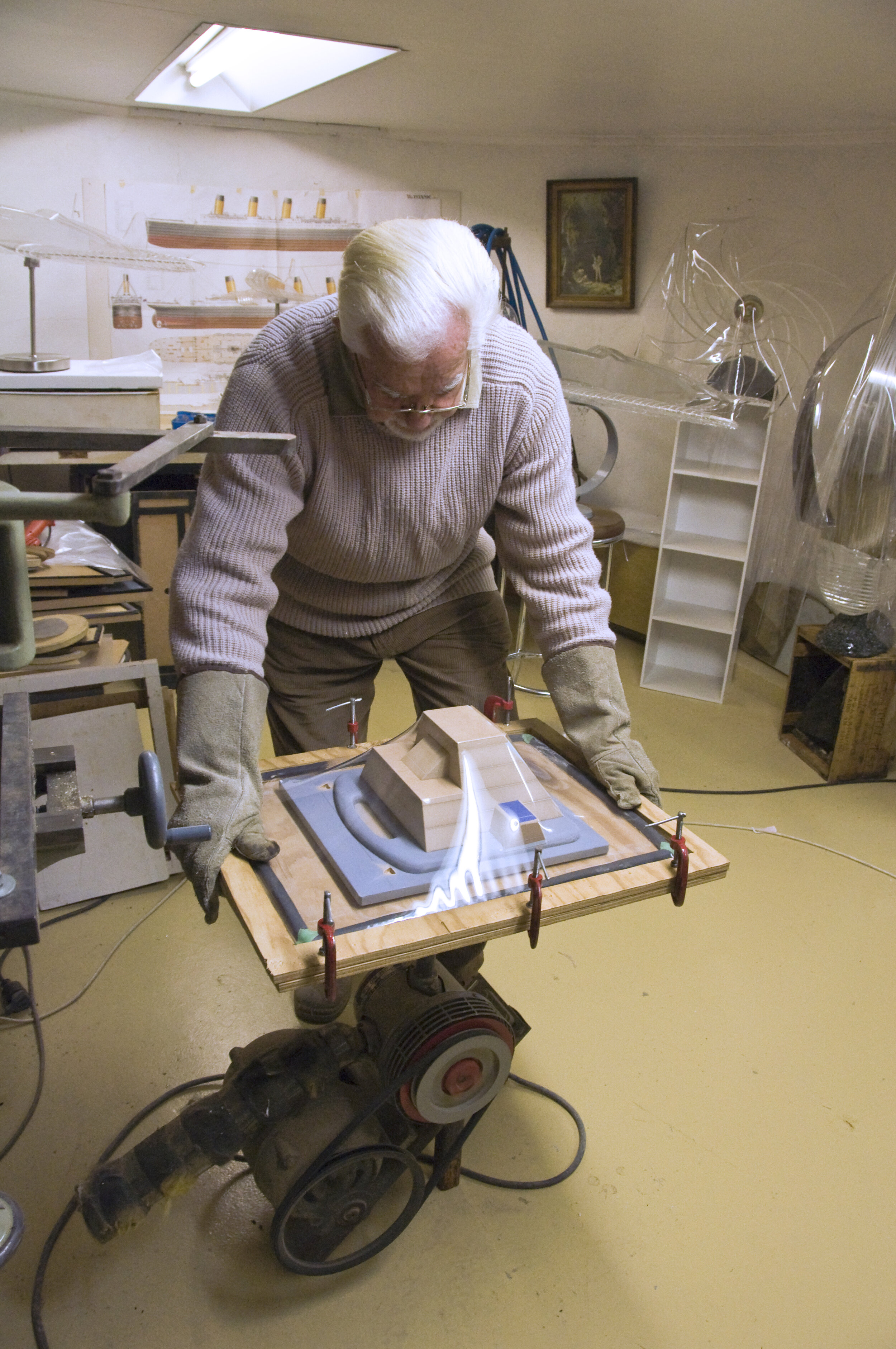 Plastic is sucked over the form by industrial vacuum pump. Note gloves for retrieving frame from oven